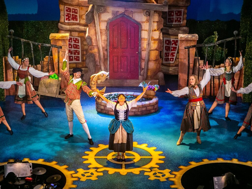 Performance of Cinderella actors waving hands towards Cinderella