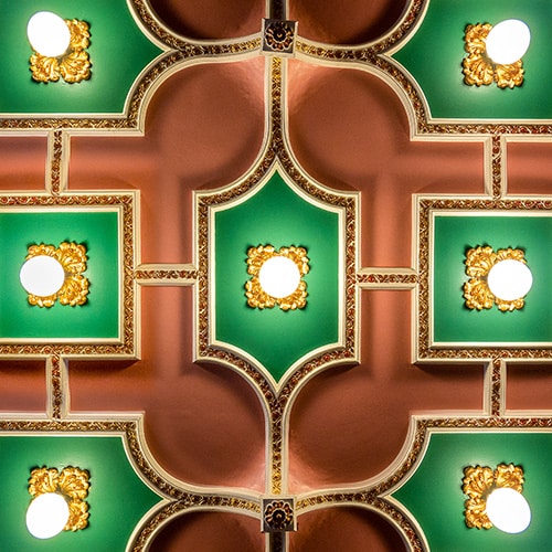 Green, gold and orange theatre foyer ceiling