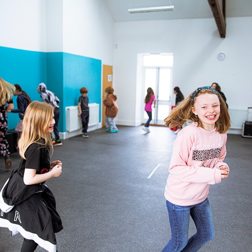 Children laughing during an activity with HYT